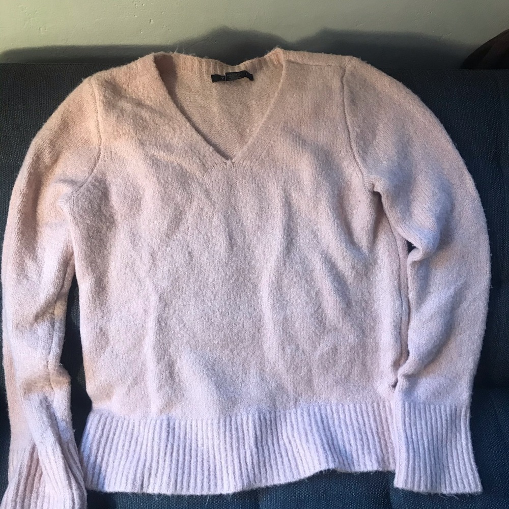 Long-sleeve light pink sweater.